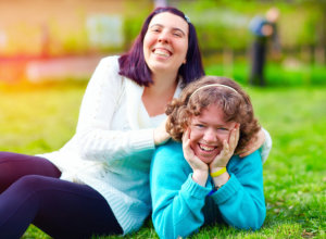 portrait of happy women with disability on spring lawn