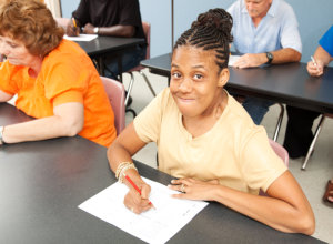 Young woman with cerebral palsy in college class