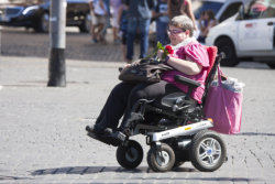 Woman with little car (wheelchair)