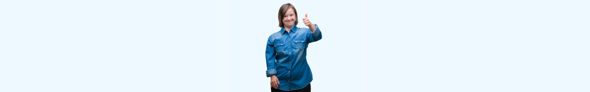 Young adult woman with down syndrome over isolated background doing happy thumbs up gesture with hand