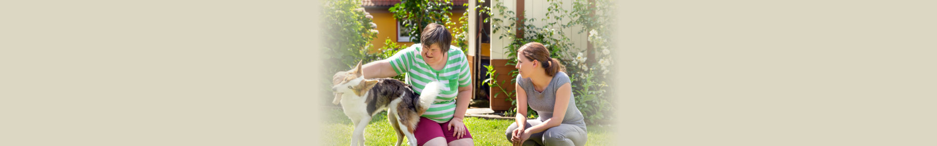 mentally disabled woman with a second woman and a companion dog, concept learning by animal assisted living